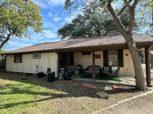 rear view of house with a lawn, a patio area, and an outdoor hangout area