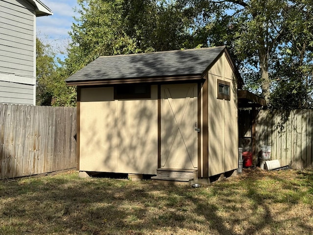 view of outbuilding with a lawn