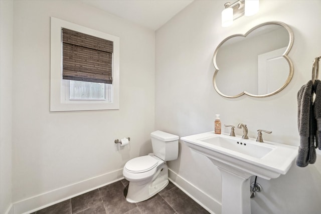 bathroom with toilet and tile patterned floors