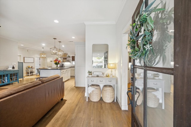 living room with light wood-type flooring and crown molding