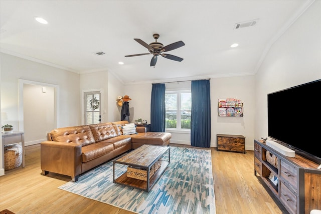 living room with crown molding, ceiling fan, and light hardwood / wood-style flooring