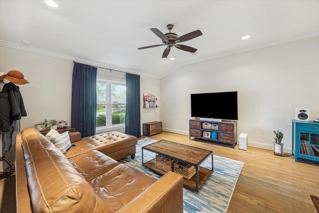 living room with ceiling fan, vaulted ceiling, crown molding, and light hardwood / wood-style floors