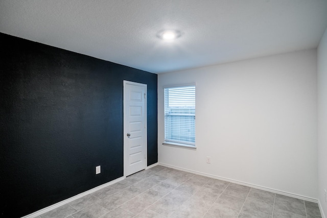 empty room with a textured ceiling