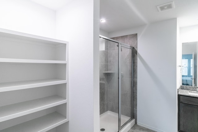 bathroom with walk in shower and vanity