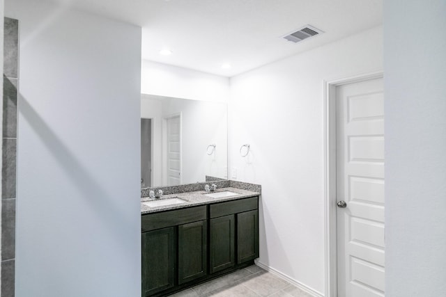 bathroom with tile patterned flooring and vanity