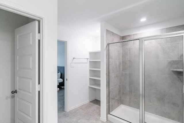 bathroom featuring an enclosed shower and tile patterned floors