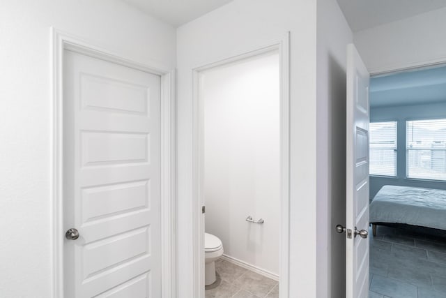 bathroom with toilet and tile patterned floors