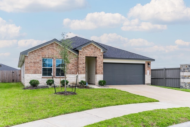 view of front of home featuring a front yard and a garage