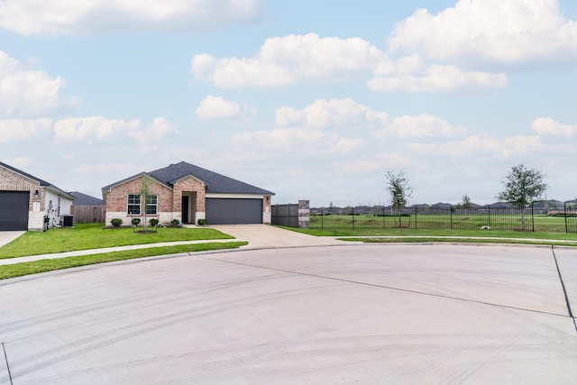 ranch-style home featuring central AC, a front yard, and a garage