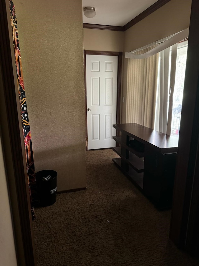 corridor featuring dark colored carpet and crown molding