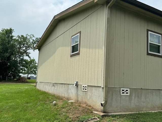 view of side of home featuring a yard