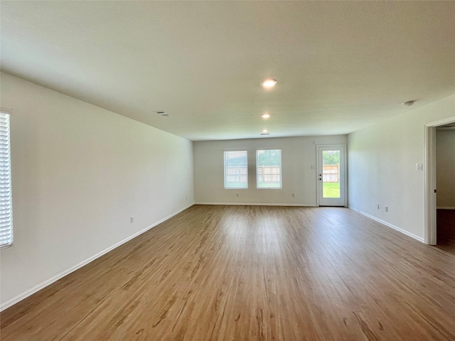 spare room with light hardwood / wood-style flooring