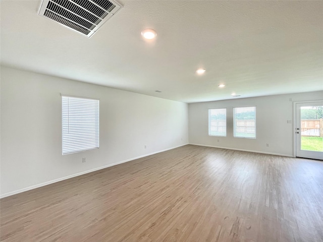 unfurnished room featuring light hardwood / wood-style flooring