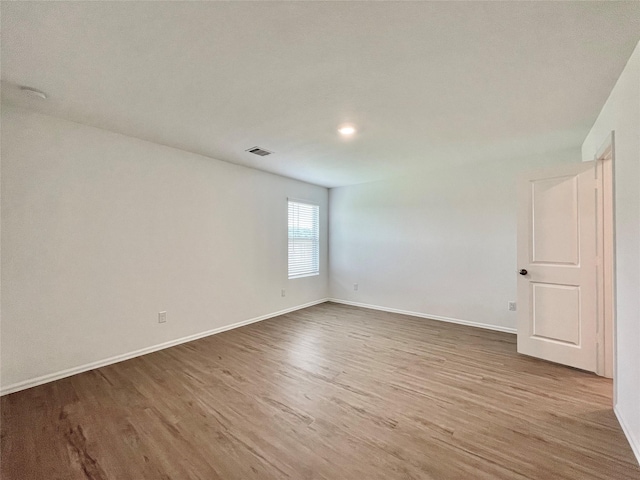 spare room featuring hardwood / wood-style flooring