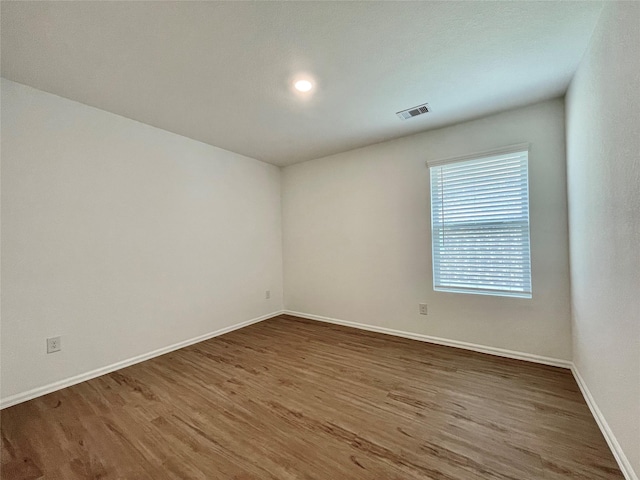 unfurnished room with dark wood-type flooring