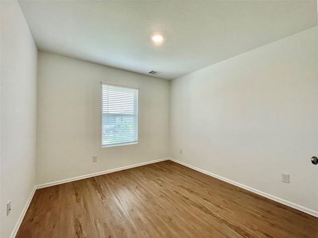 empty room with wood-type flooring