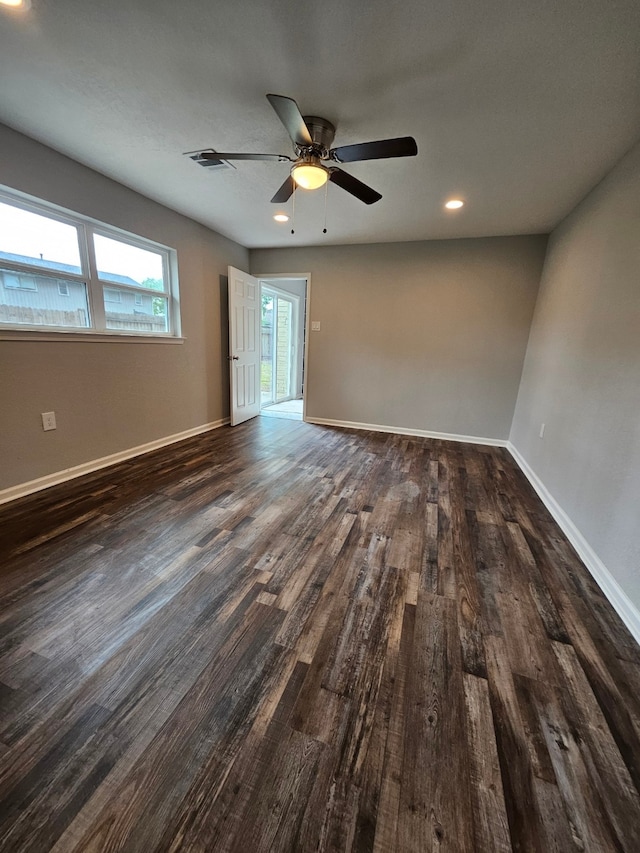 spare room with ceiling fan and dark hardwood / wood-style flooring