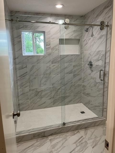 bathroom with a shower with shower door