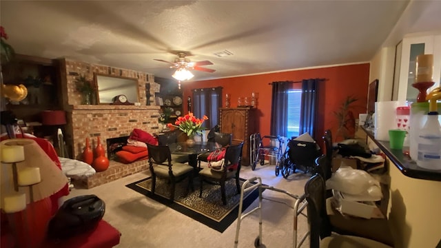 dining space with a fireplace, ceiling fan, crown molding, and light carpet