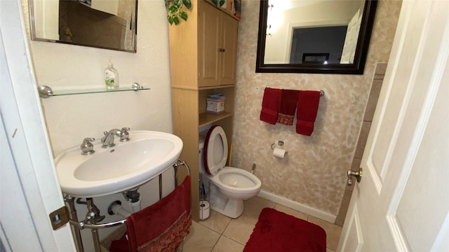 bathroom with sink, tile patterned flooring, and toilet