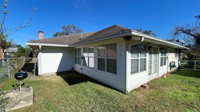 view of property exterior featuring a lawn and cooling unit