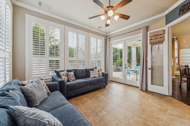 living room featuring ceiling fan, light tile patterned flooring, french doors, and crown molding