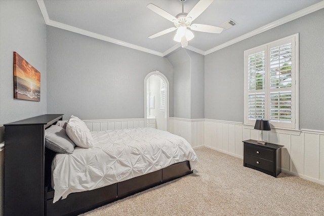 bedroom featuring ceiling fan, light colored carpet, and crown molding