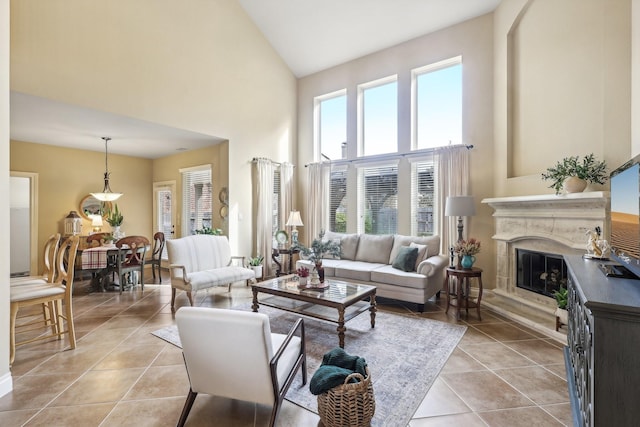 living room featuring a wealth of natural light, high vaulted ceiling, and light tile patterned floors