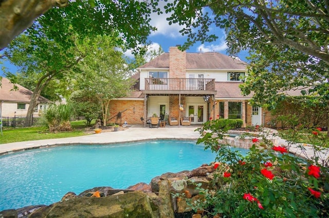 view of swimming pool with french doors and a patio area