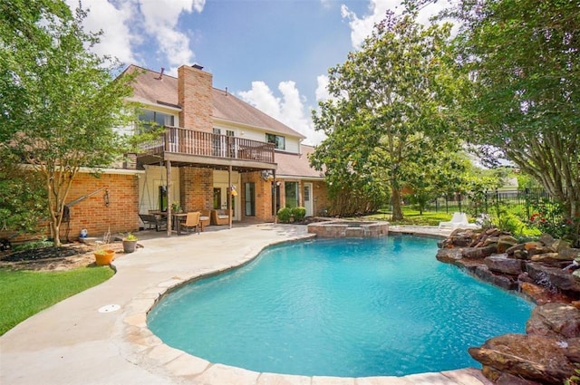 view of pool with a patio area and an in ground hot tub