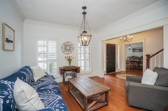 living room with a chandelier, hardwood / wood-style floors, and ornamental molding