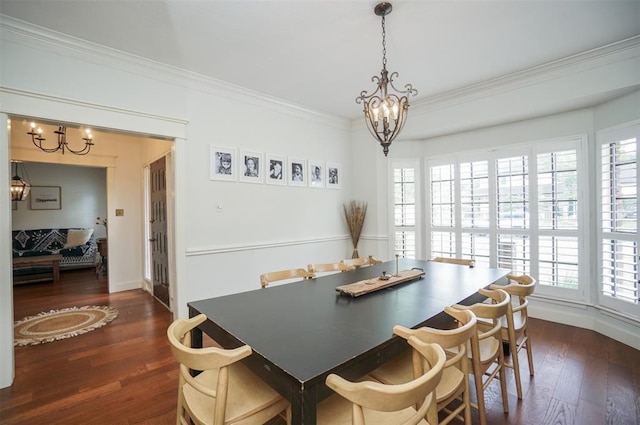 dining room with ornamental molding, a notable chandelier, and dark hardwood / wood-style floors