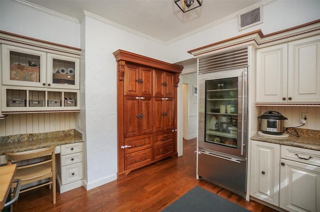 kitchen featuring beverage cooler, stone counters, ornamental molding, dark hardwood / wood-style flooring, and white cabinetry