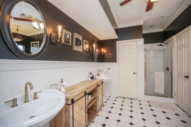 bathroom featuring dual sinks, walk in shower, ceiling fan, and crown molding