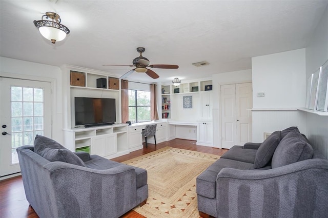 living room featuring ceiling fan and hardwood / wood-style flooring