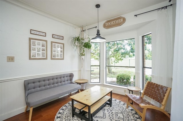 sitting room with crown molding, a healthy amount of sunlight, and dark hardwood / wood-style floors