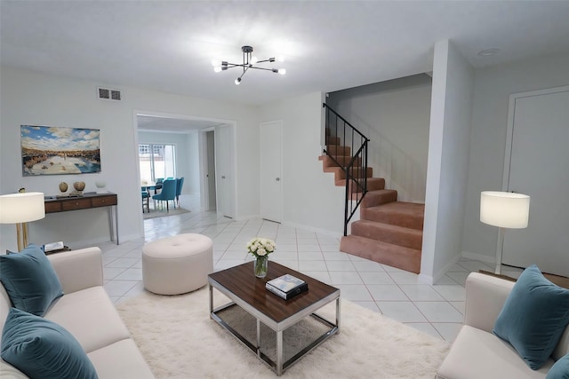 living room featuring light tile patterned flooring and a chandelier