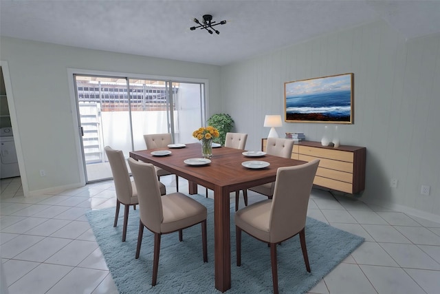 dining space with washer / dryer and light tile patterned flooring