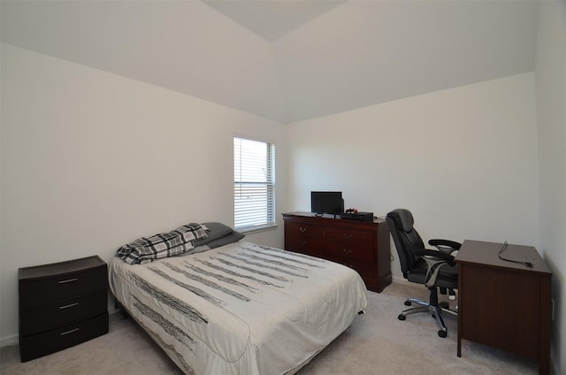 carpeted bedroom with lofted ceiling