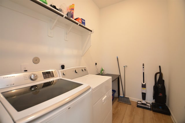 laundry room featuring light wood-type flooring and washing machine and clothes dryer