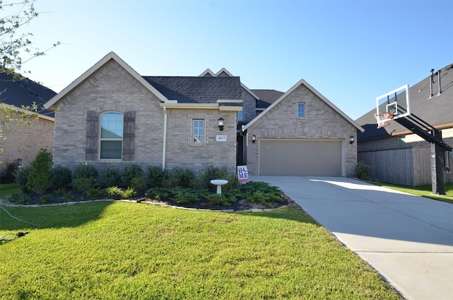 view of front of house featuring a front yard and a garage