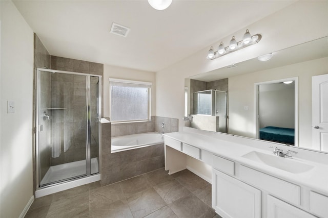 bathroom with tile patterned flooring, vanity, and plus walk in shower