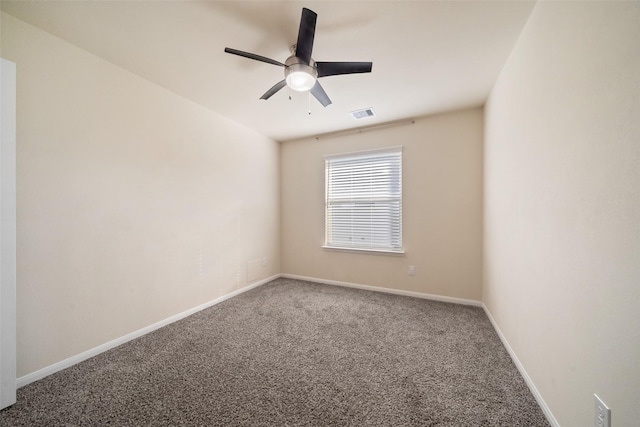 spare room featuring carpet floors and ceiling fan