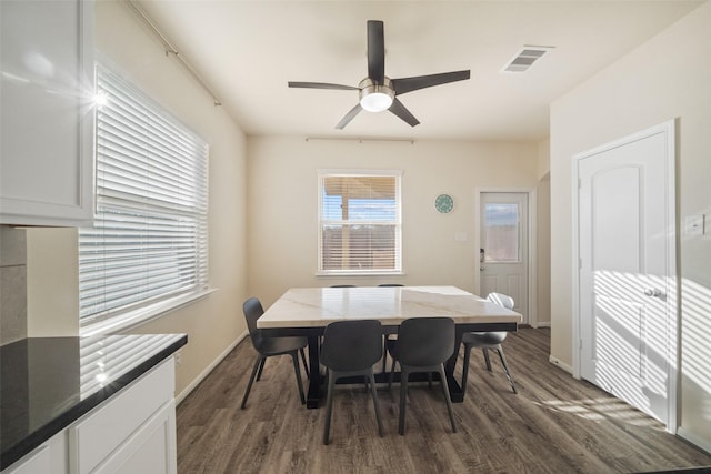 dining area featuring ceiling fan and dark hardwood / wood-style flooring