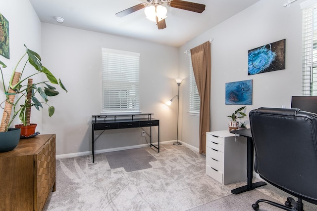 carpeted office featuring ceiling fan