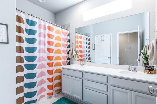 bathroom featuring curtained shower and vanity