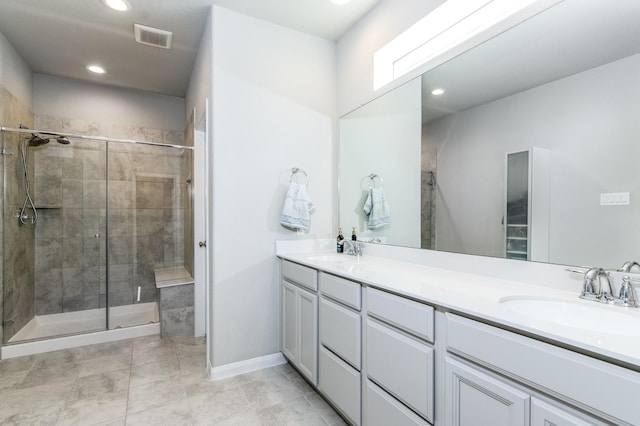 bathroom featuring vanity and a shower with shower door