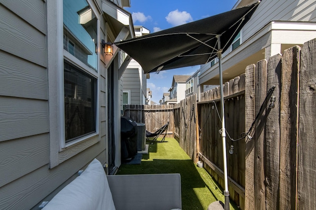 view of property exterior featuring central AC unit and a lawn