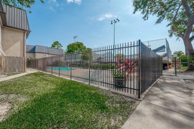 view of swimming pool with a lawn