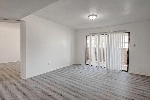 empty room with light hardwood / wood-style flooring